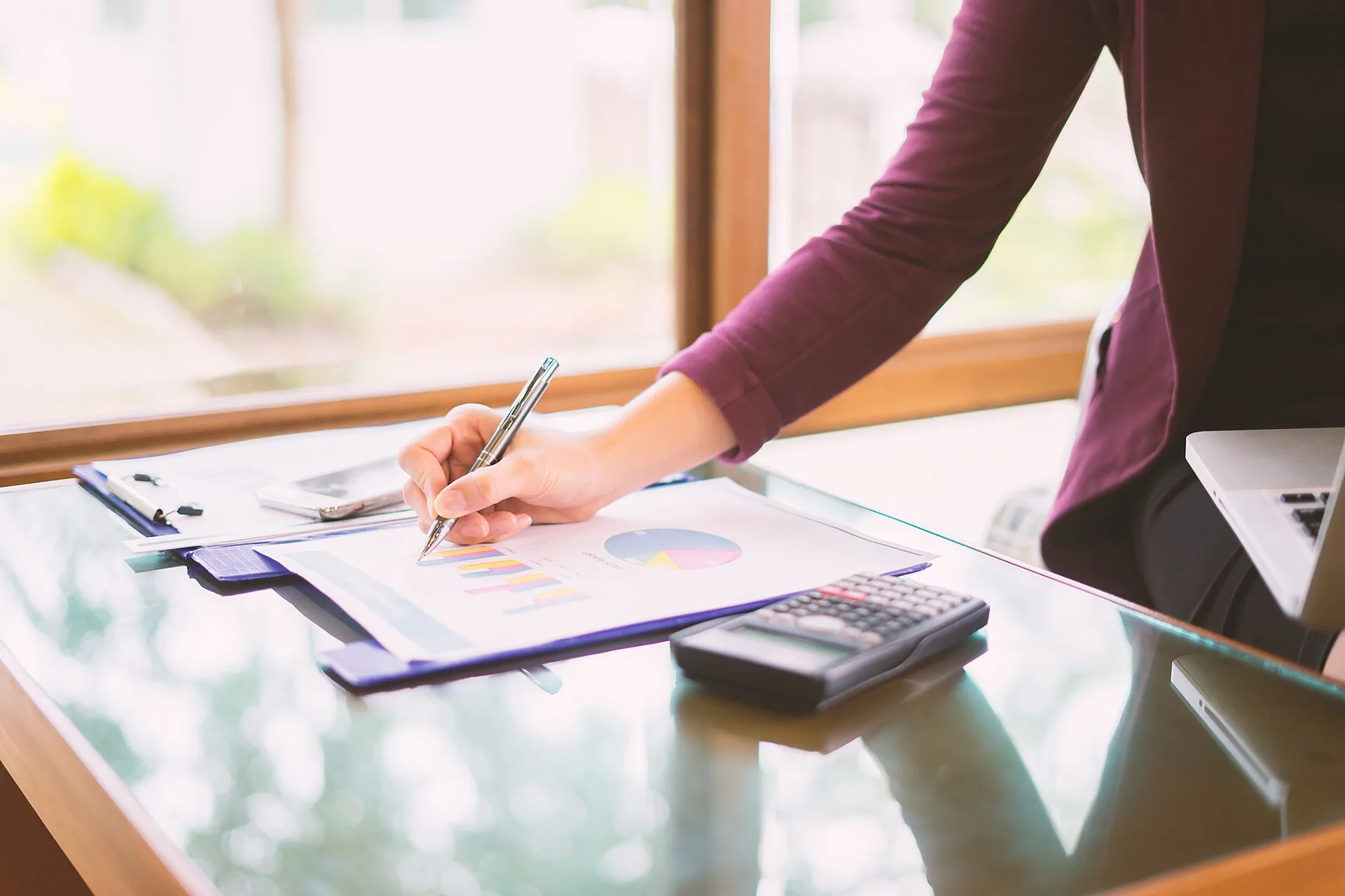 Hand business woman pointing paper data analyze chart on desk at office room.young girl writing into her diary about recipient address on mailing envelope,female hands sending letter,business concept. Grants for women: four structures, scam signs, and where to verify listings