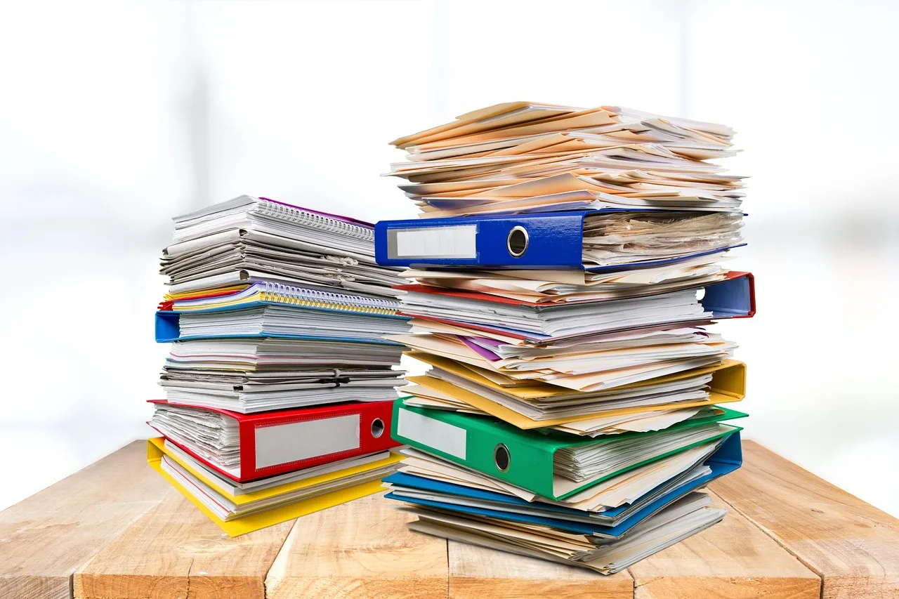 folders, files, office, binders, desk, paper, stack of paper, office work, paperwork, documents, folders, paperwork, paperwork, paperwork, paperwork, paperwork. State grant mistakes to check before signing